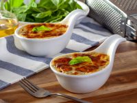 Baked spinach with cheese on a wooden background