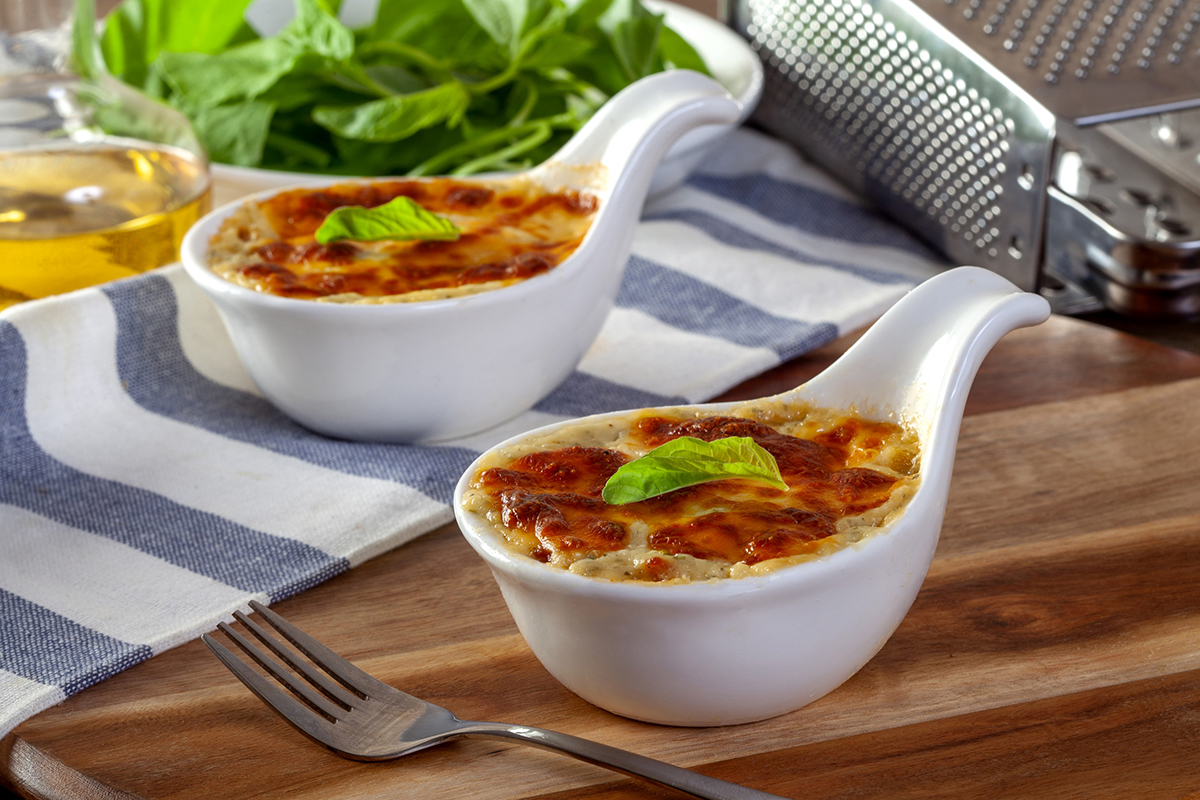 Baked spinach with cheese on a wooden background